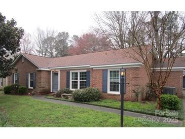 Charming brick home with well-maintained lawn and mature trees in a peaceful neighborhood at 6792 Stoney Ridge Rd, Matthews, NC 28104