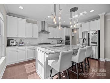 Modern kitchen with stainless steel appliances, granite counters, and island with bar seating at 840 Pecan Tree Ln, Fort Mill, SC 29715