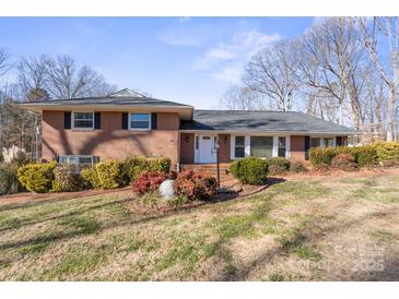 Brick ranch house with mature trees and landscaping at 220 Augusta Dr, Statesville, NC 28625