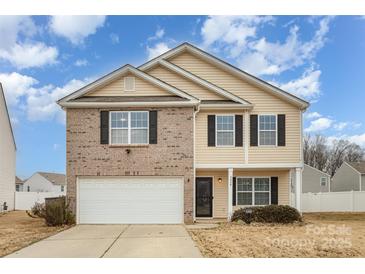 Inviting two-story home featuring a brick facade, attached garage, and well-maintained landscaping at 3028 Apple Orchard Pl, Dallas, NC 28034