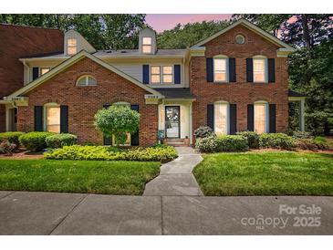 Charming brick home featuring a well-manicured lawn, dark shutters, and a welcoming walkway at 9108 Nolley Ct # B, Charlotte, NC 28270
