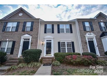 Brick front exterior of charming townhome with landscaping at 10946 Garden Oaks Ln, Charlotte, NC 28273