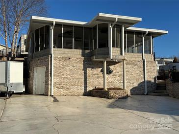 Brick house with a screened porch and attached garage at 130 Badin Lake Cir, New London, NC 28127