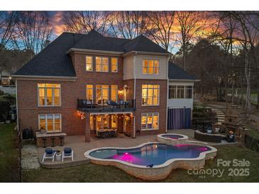 Stunning backyard with a pool, patio, balcony, outdoor seating, and beautiful sunset views at 162 Wild Harbor Rd, Mooresville, NC 28117