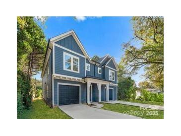 Two-story blue house with a two-car garage and landscaped yard at 2149 Highland St, Charlotte, NC 28208