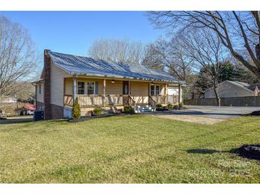 Charming home featuring a cozy front porch, well-maintained lawn, and convenient driveway at 236 Ervin Rd, Mooresville, NC 28117