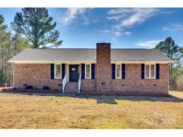 Charming brick home featuring black shutters, a brick chimney, and a well-maintained lawn at 3331 Center Rd, Chester, SC 29706