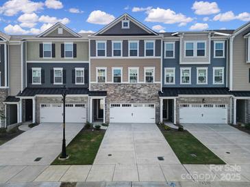 Attractive townhouse exteriors with stone accents, individual garages, and manicured lawns at 432 Burr St, Indian Trail, NC 28079