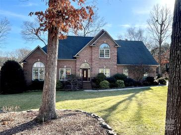 Brick house with a large front yard and mature trees at 6020 Havencrest Nw Ct, Concord, NC 28027