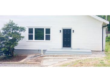 Charming home featuring a black front door, gray steps, and a freshly painted white exterior at 105 N Inman Ave, Bessemer City, NC 28016