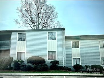 Charming light blue two-story condo with well-maintained landscaping at 10933 Harrowfield Rd, Charlotte, NC 28226