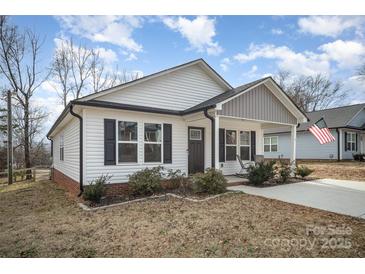 Charming single-story home with vinyl siding, dark shutters, and a welcoming front porch at 1140 Roberts St, China Grove, NC 28023