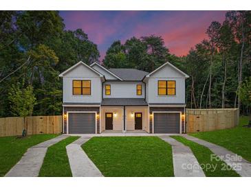 Charming exterior view of a modern two-story home featuring a well-manicured lawn and a two-car garage at 118 I K Beatty St, Charlotte, NC 28214
