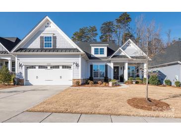Two-story home with gray siding, landscaping, and a two-car garage at 14543 Crosswater Ln, Charlotte, NC 28278