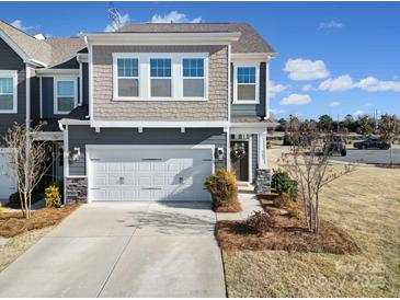 Charming townhome featuring a two-car garage and a mix of siding and stone accents at 343 Embers Ln, Clover, SC 29710