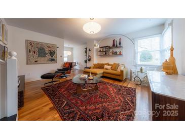 Bright living room with a stylish mustard-colored sofa, unique rug, and modern decor at 544 Wakefield Dr, Charlotte, NC 28209