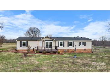Charming ranch style home with a covered front porch and well-maintained landscaping at 760 Tomlin Mill Rd, Statesville, NC 28625