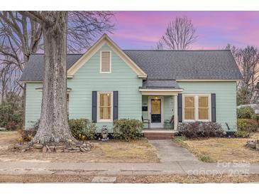 Charming light green house with a classic design and landscaping at 202 W Main St, Cherryville, NC 28021