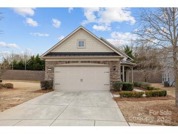 Charming home featuring a two-car garage, stone accents, and a well-maintained lawn at 250 Cherry Tree Dr, Fort Mill, SC 29715