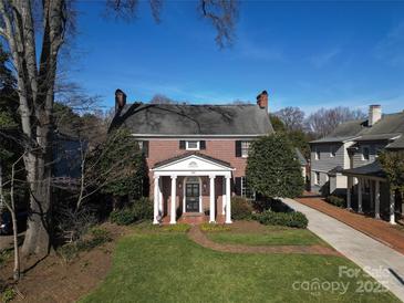 Brick front of charming two-story home with a well-manicured lawn at 258 Fenton Pl, Charlotte, NC 28207