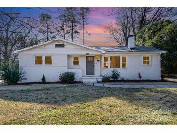 Charming single-story home boasts a well-maintained yard and neutral-colored brick at 2624 Ashley Rd, Charlotte, NC 28208