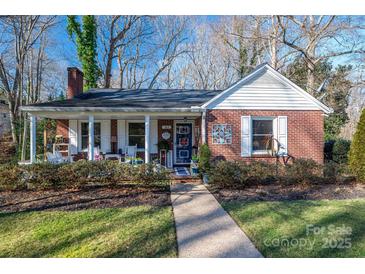 Brick ranch house with covered porch and landscaped yard at 303 Edgewood Rd, Shelby, NC 28150