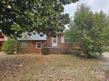 Brick ranch home with steps leading to the front door, and a partially visible yard at 3219 Sutton Dr, Charlotte, NC 28216