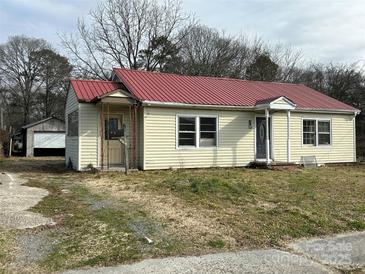 Ranch style home featuring a red metal roof and detached garage at 649 Arch Dr, Rock Hill, SC 29730