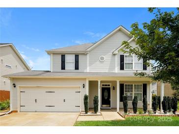 Two-story house with light beige vinyl siding, black shutters, and a front porch at 733 Jones Branch Rd, Fort Mill, SC 29715