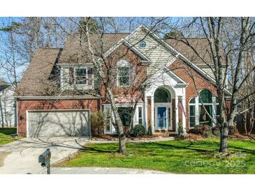 Charming brick home with a two-car garage, manicured lawn and inviting front entrance at 7505 Torphin Ct, Charlotte, NC 28269