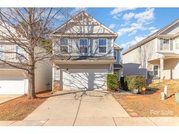 Charming two-story home with a two-car garage, neat landscaping, and a welcoming facade in a desirable neighborhood at 8411 Washoe Pine Ln, Charlotte, NC 28215