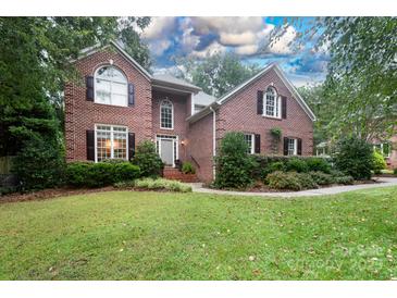 Brick home with landscaping, inviting front porch, and two-car garage at 1548 Summit View Dr, Rock Hill, SC 29732