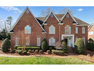 Charming red brick home boasts meticulous landscaping and striking architectural details at 1604 Windy Ridge Rd, Charlotte, NC 28270