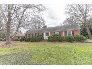 Brick ranch house with mature trees and a well-manicured lawn at 2541 Pinewood Rd, Gastonia, NC 28054