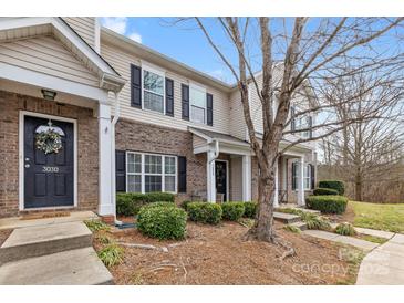 Charming townhome featuring brick accents, black shutters, and a welcoming front entrance at 3028 Summerfield Ridge Ln, Matthews, NC 28105