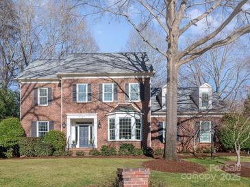 Charming two-story brick home featuring a manicured lawn and a gray front door at 3421 Walston Ln, Charlotte, NC 28211