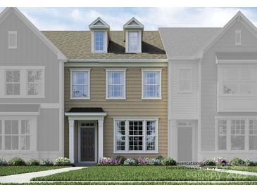 Two-story tan home with white trim and landscaping at 4519 Potters Wheel Dr, Fort Mill, SC 29715