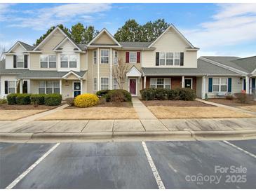 Two-story townhome with neutral siding and landscaping at 7310 Sun Dance Dr, Fort Mill, SC 29707