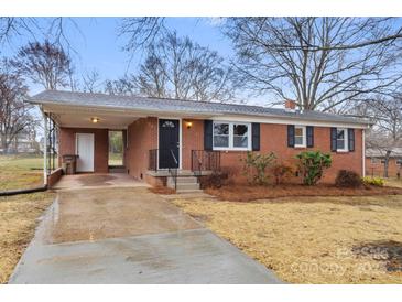 Charming single-story brick home with a covered carport and well-maintained front yard at 901 Wyke Rd, Shelby, NC 28150