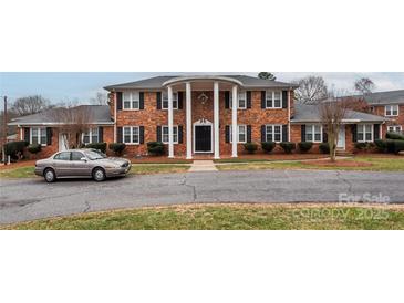 Brick building with columns, landscaping, and ample parking at 904 Mcalway Rd # B, Charlotte, NC 28211