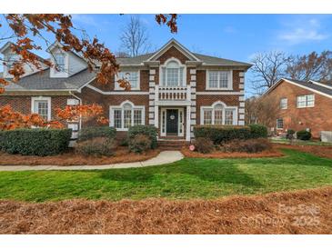 Stately brick home featuring classic architectural details, manicured landscaping, and a welcoming front entrance at 10417 Sutherby Dr, Charlotte, NC 28277