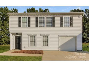 Two-story house with white siding, black shutters, and a two-car garage at 152 Oliver St, York, SC 29745