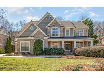 Charming two-story brick home with landscaped yard and inviting front porch at 1806 Grayscroft Dr, Waxhaw, NC 28173