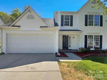 Two-story house with white siding, a large garage, and a well-maintained lawn at 2139 Mallard Green Pl, Charlotte, NC 28262