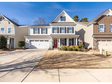 Charming two-story home features a well-maintained lawn and a two-car garage at 223 Blossom Ridge Dr # 137, Mooresville, NC 28117