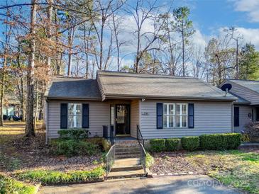 Charming single-story home featuring gray siding, dark shutters, and a well-manicured front yard at 2710 Redbud Ln, Fort Mill, SC 29715