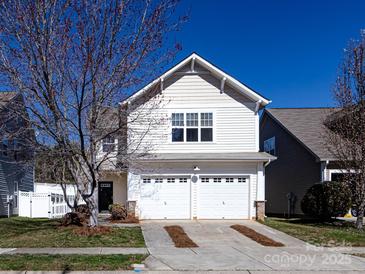 Charming two-story home with a two-car garage and manicured lawn at 9613 Long Hill Dr, Charlotte, NC 28214