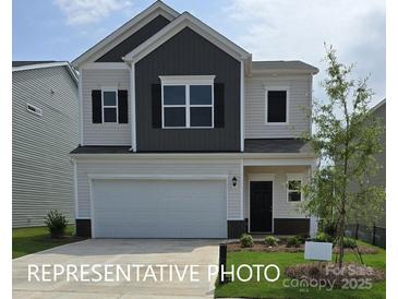 Two-story house with gray and beige exterior, two-car garage, and landscaped lawn at 1129 Red River Dr, Salisbury, NC 28144