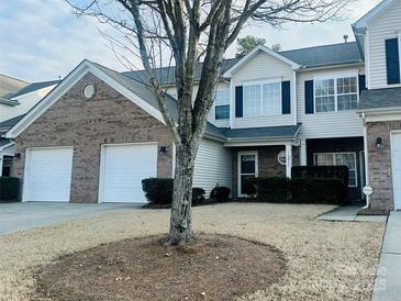 Charming townhome with a two-car garage, neat landscaping, and inviting front entrance at 11837 Stratfield Place Cir, Pineville, NC 28134