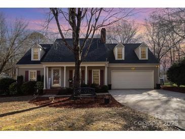 Charming one story home with covered front porch, front yard and attached garage at 11918 Parks Farm Ln, Charlotte, NC 28277